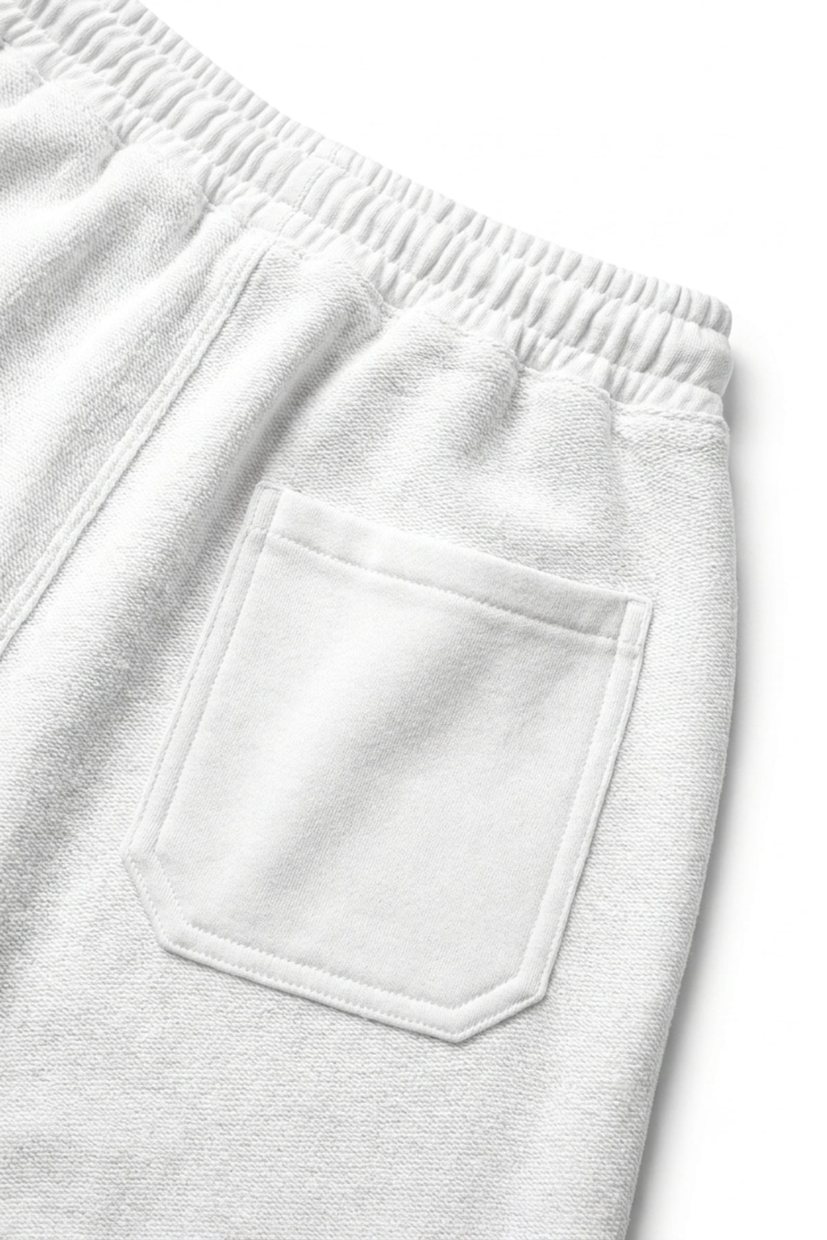 Close-up rear view of the Classic Lounge Lightweight Terry Trousers in Optic White, detailing the patch pocket and fine loopback French terry weave.