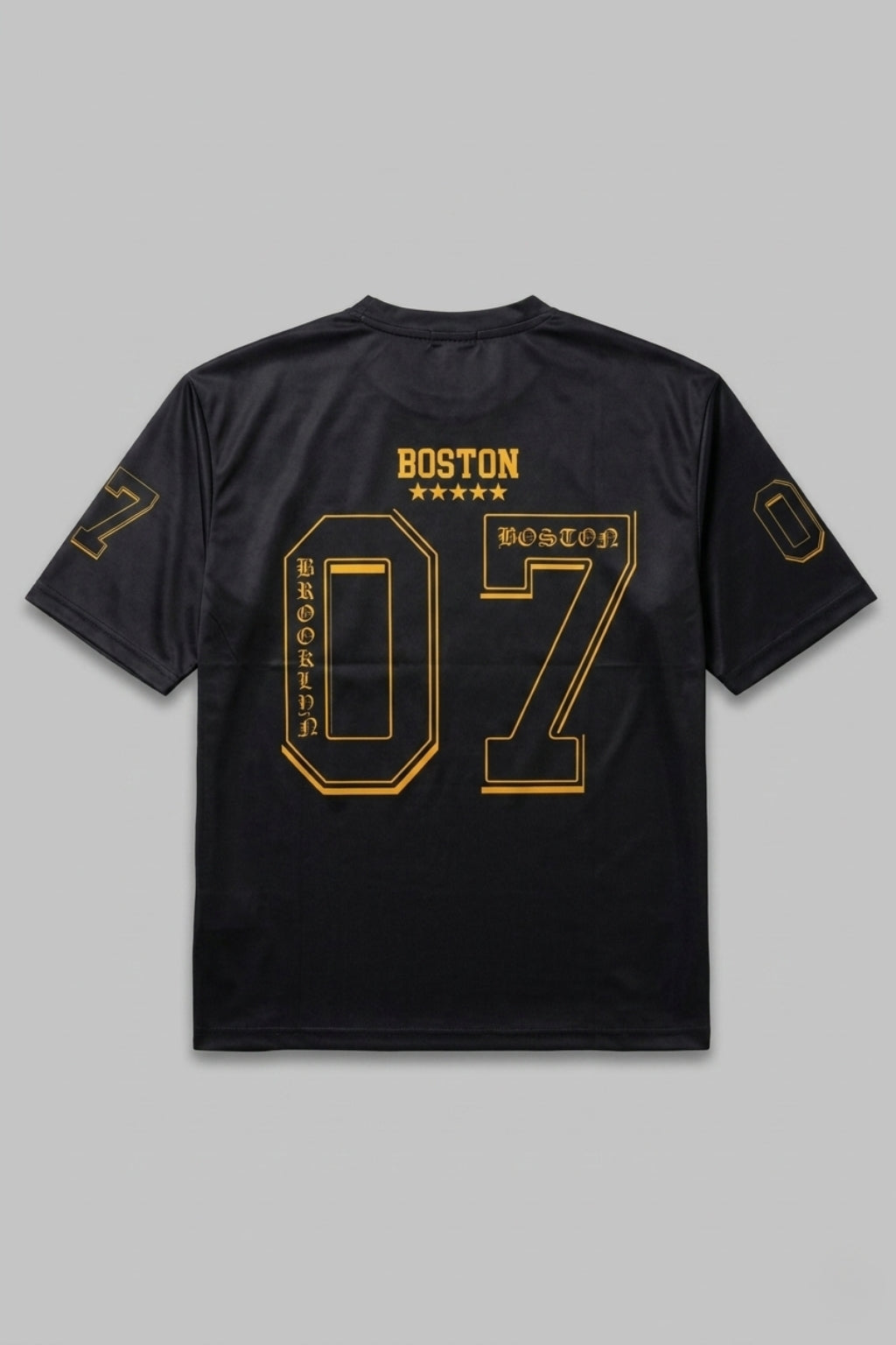 Full back flat lay of The Coastal Hybrid Jersey in Black showing boxy silhouette and athletic graphics.