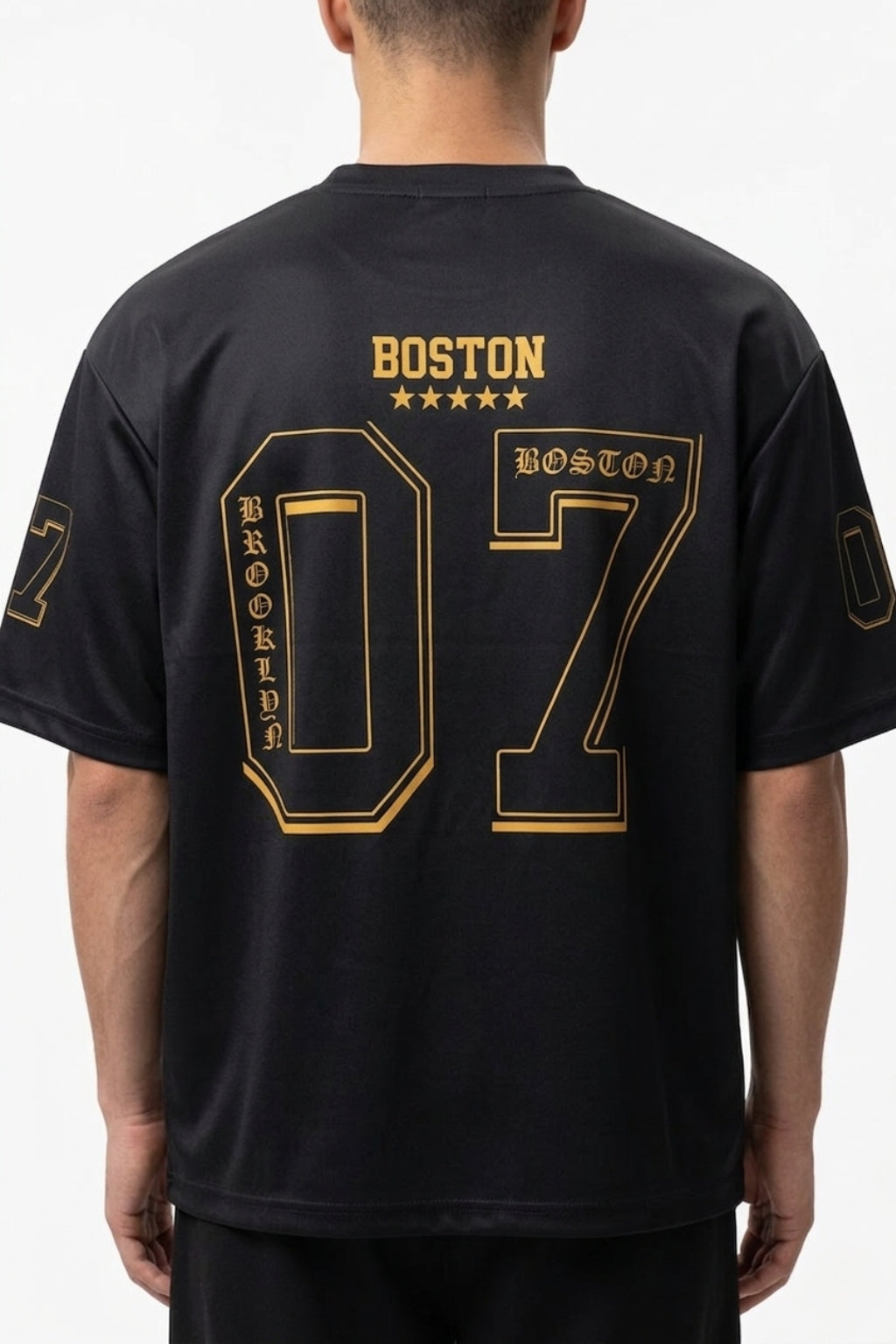 Back view of model showing the drop-shoulder drape and large "07" back print of the Coastal Hybrid Jersey.