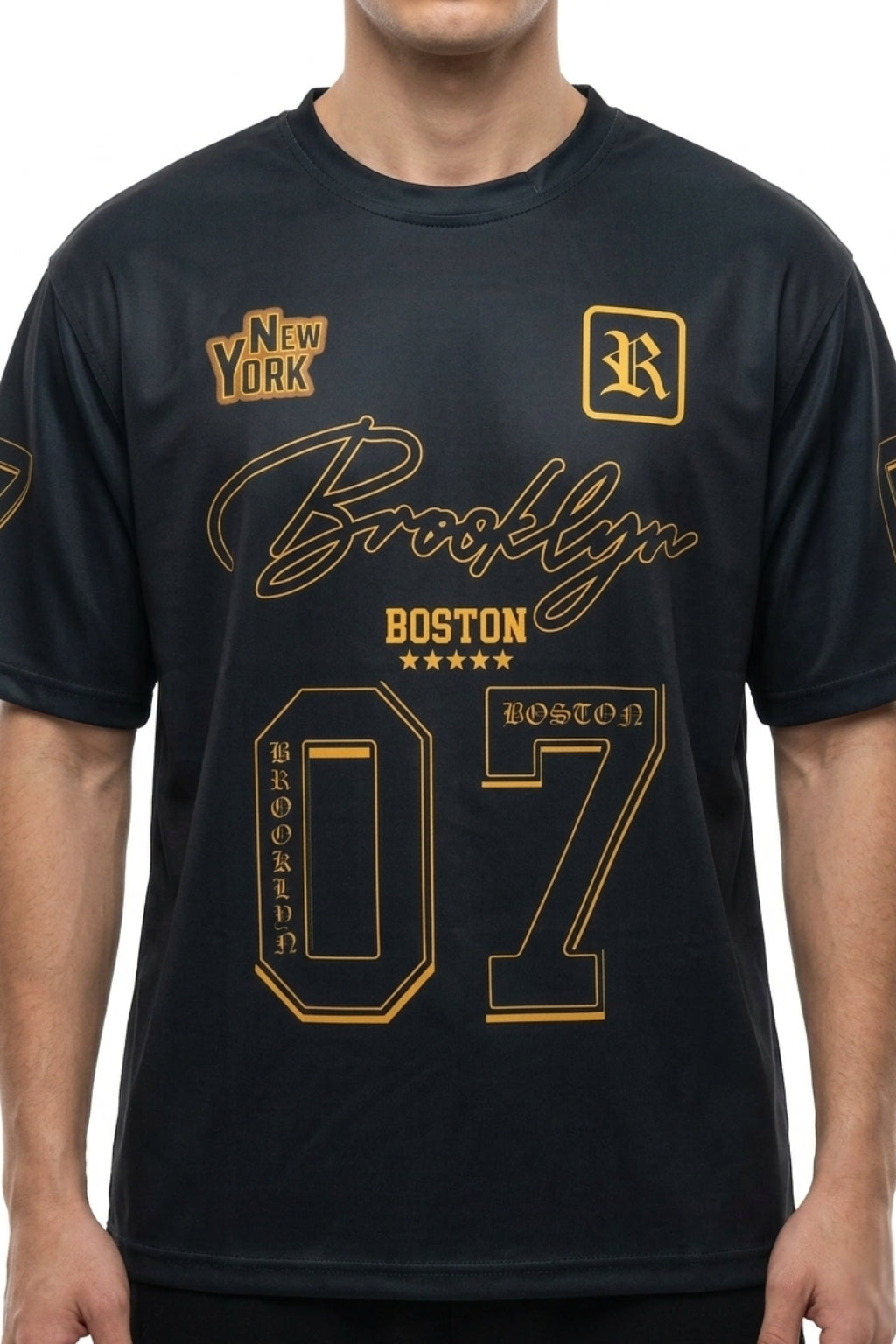 Front view of model wearing The Coastal Hybrid Jersey in Black showing oversized fit and chest graphics.