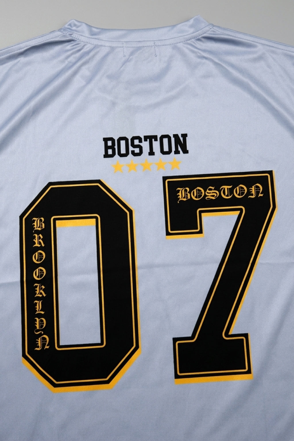 Detail shot of the back graphic and technical interlock fabric texture of the Coastal Hybrid Jersey.