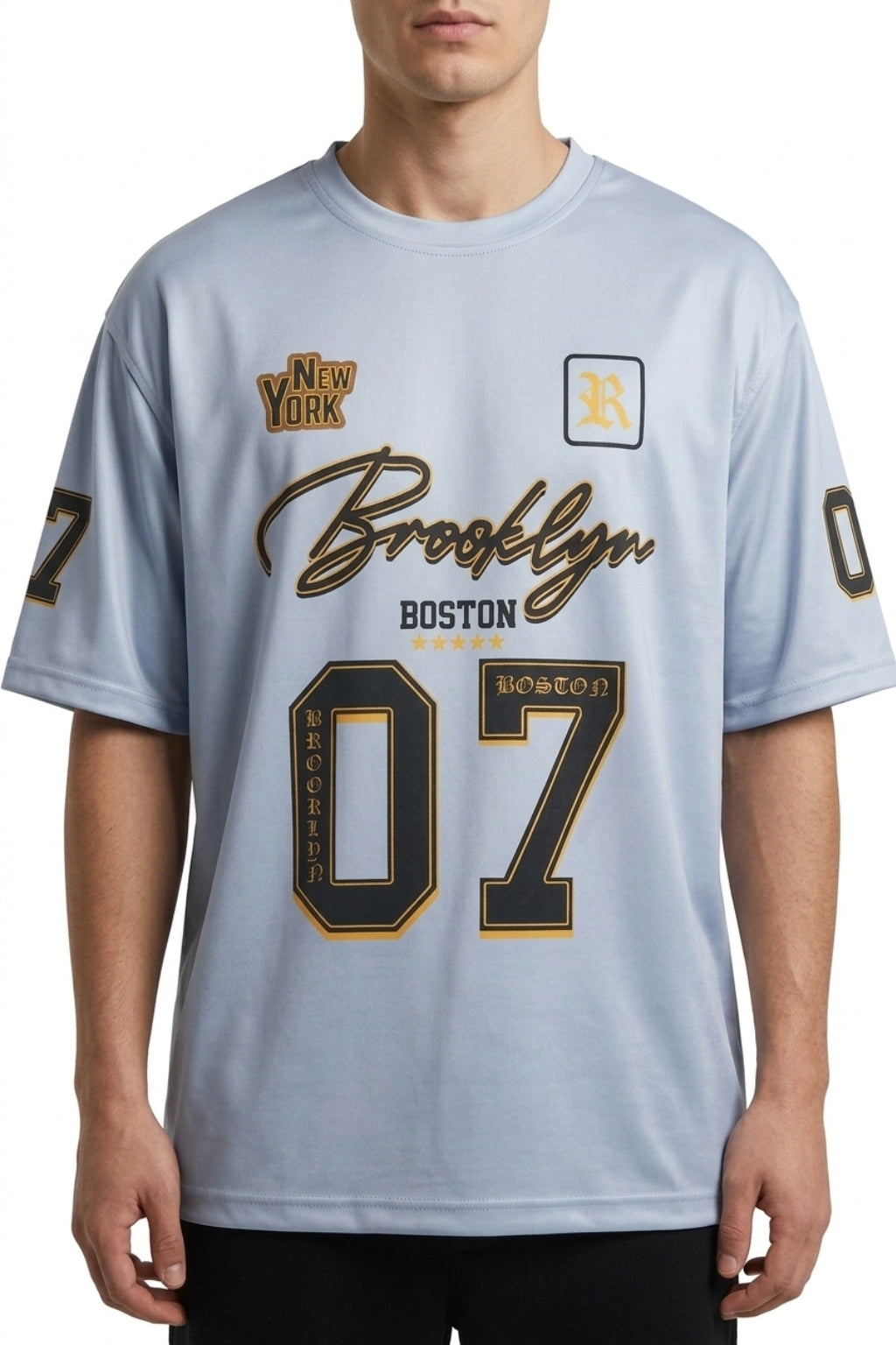 Front view of model wearing The Coastal Hybrid Jersey in Carolina Blue showing oversized fit and chest graphics.