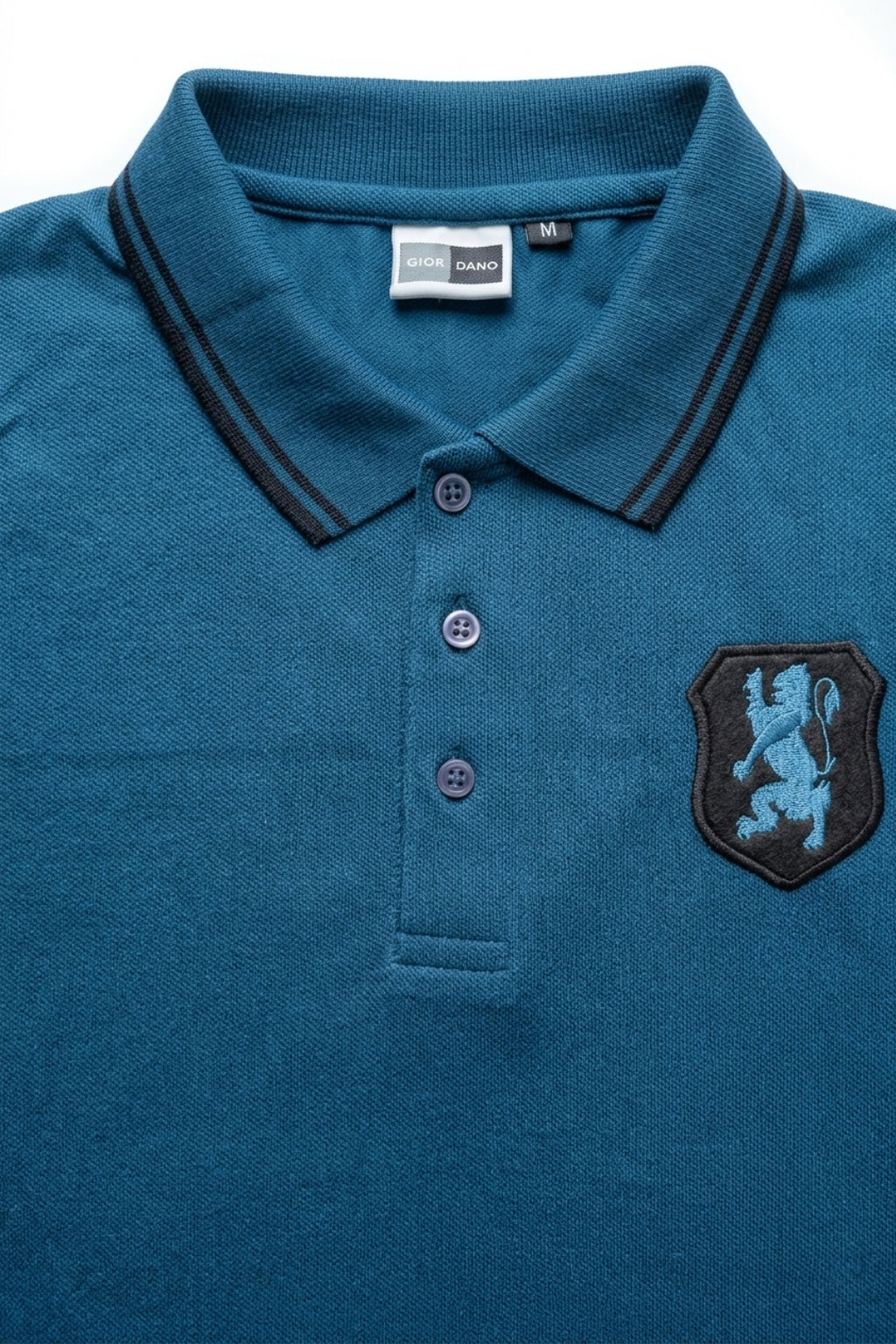 Close-up detail of Eliteez embroidered Lion Pique Polo – Teal Blue premium pique and embroidered logo.