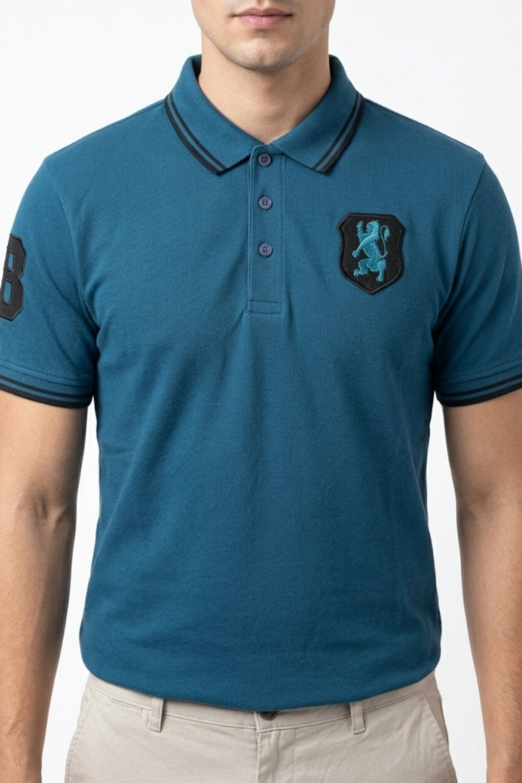 Male model wearing the Eliteez embroidered Lion Pique Polo – Teal Blue for a smart-casual look.