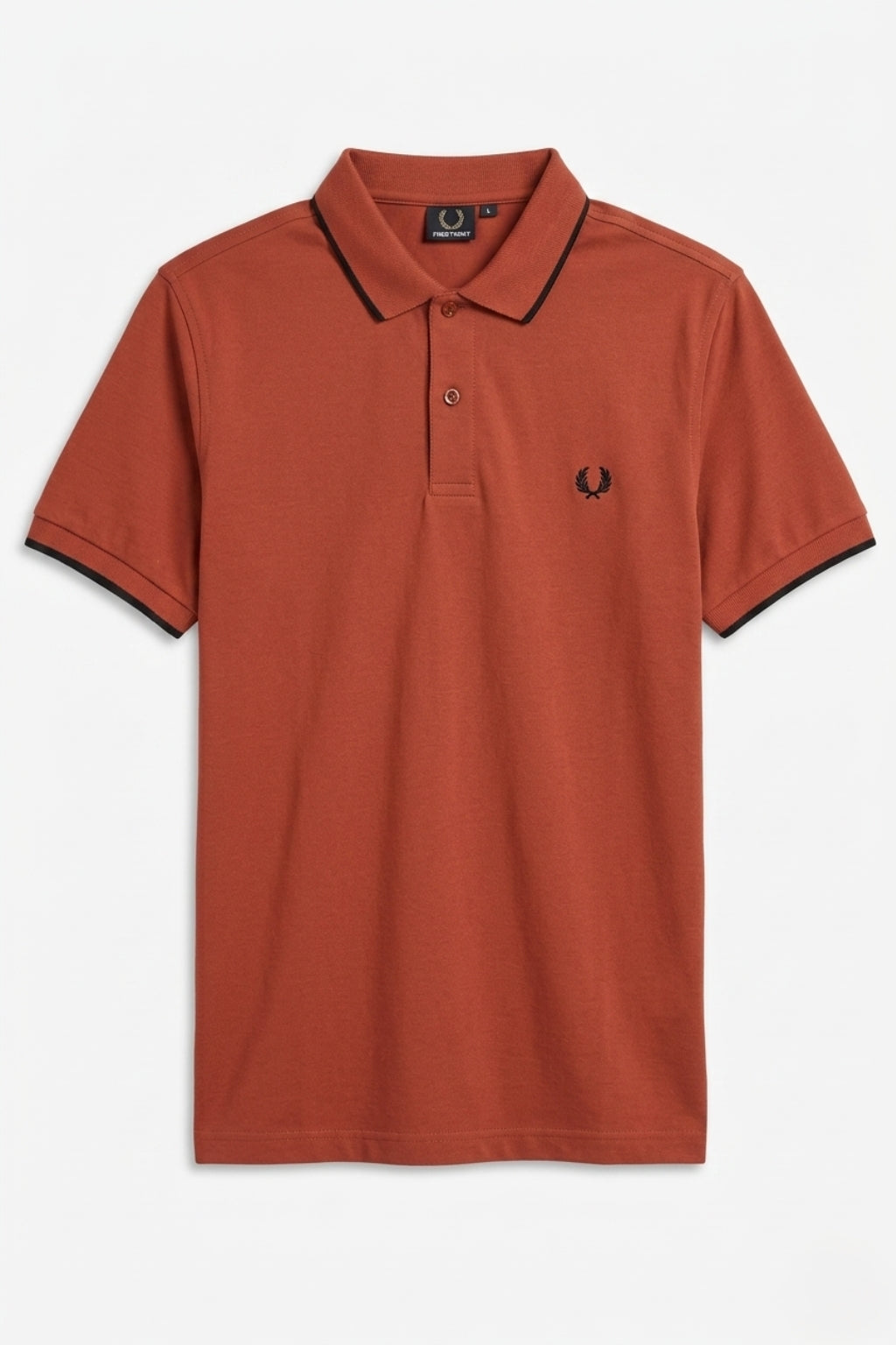 Close-up of laurel embroidery on Eliteez Heritage Polo Rust Orange