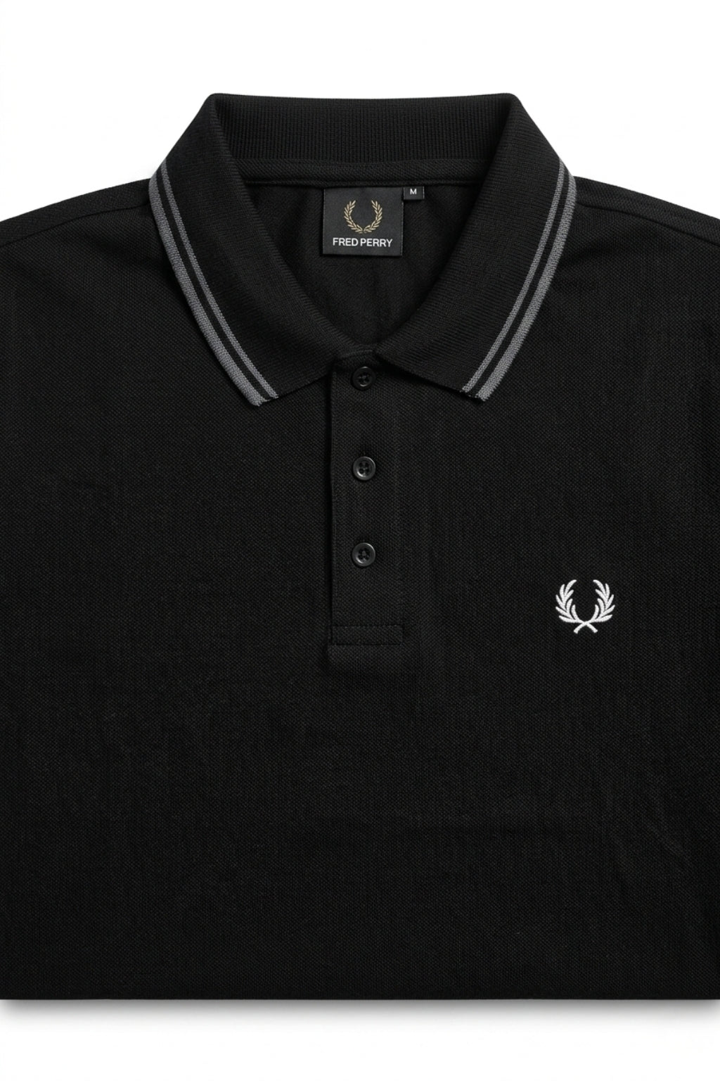 Close-up detail of Eliteez Heritage Twin-Tip Polo - Black premium pique and embroidered logo.