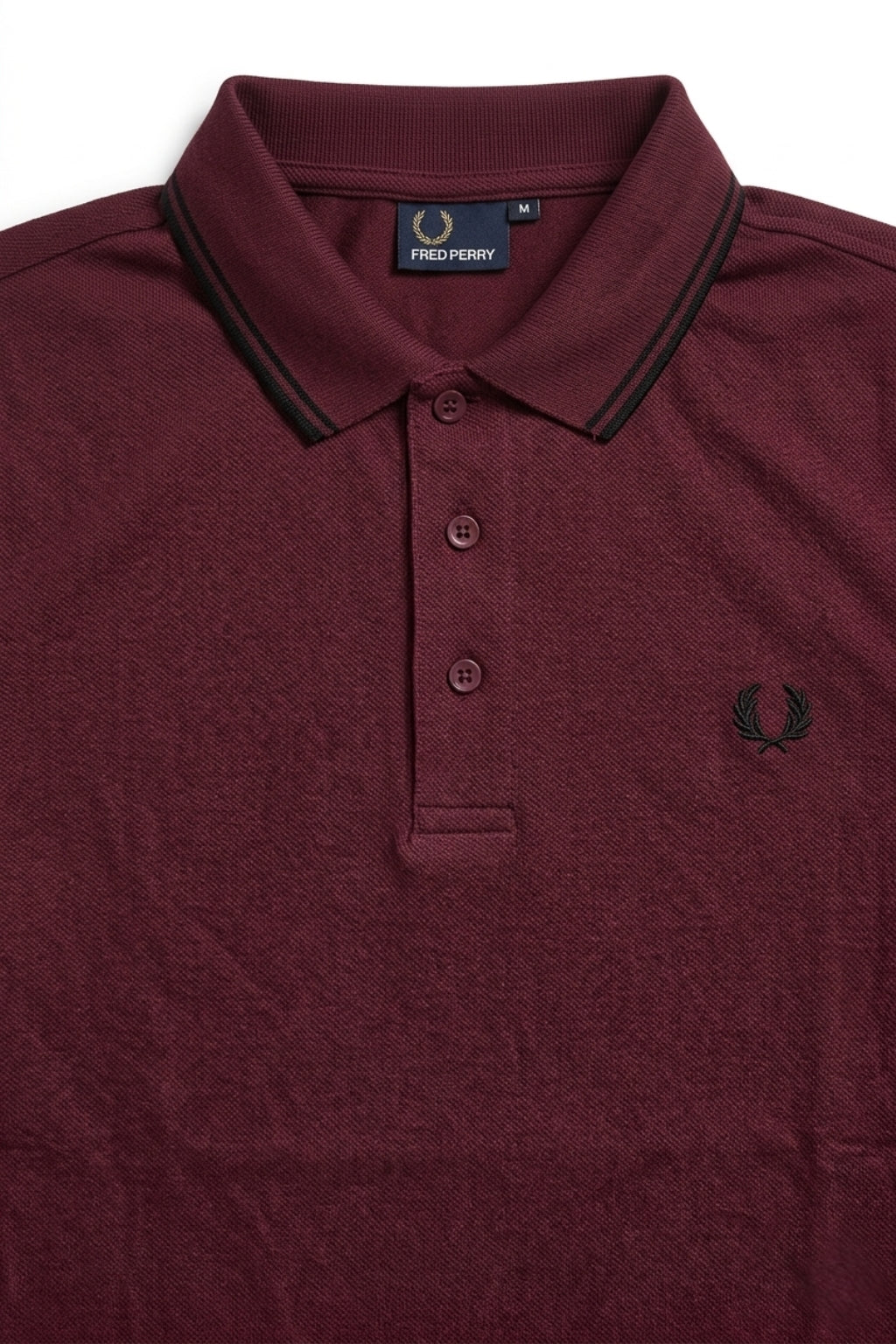 Close-up detail of Eliteez Heritage Twin-Tip Polo - Burgundy premium pique and embroidered logo.