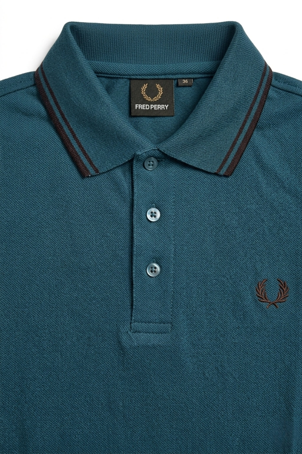 Close-up detail of Eliteez Heritage Twin-Tip Polo - Dark Teal premium pique and embroidered logo.
