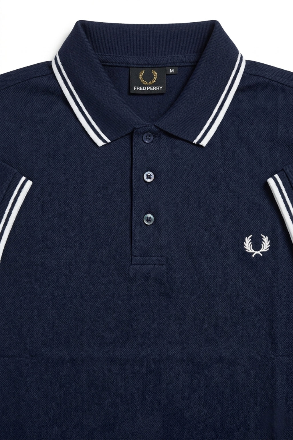 Close-up detail of Eliteez Heritage Twin-Tip Polo - Navy Blue premium pique and embroidered logo.