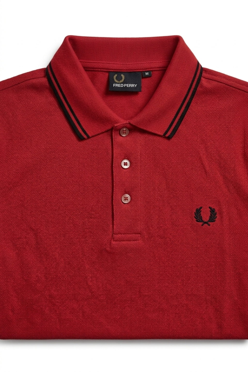 Close-up detail of Eliteez Heritage Twin-Tip Polo - Red premium pique and embroidered logo.