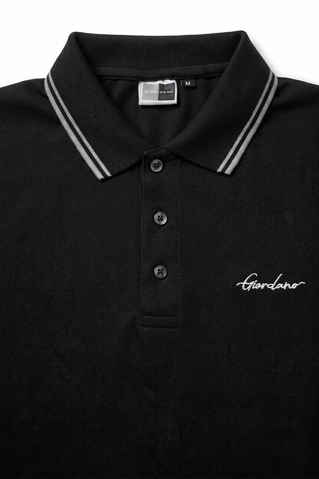 Close-up detail of Eliteez Signature Twin-Tip Polo - Black premium pique and embroidered logo.
