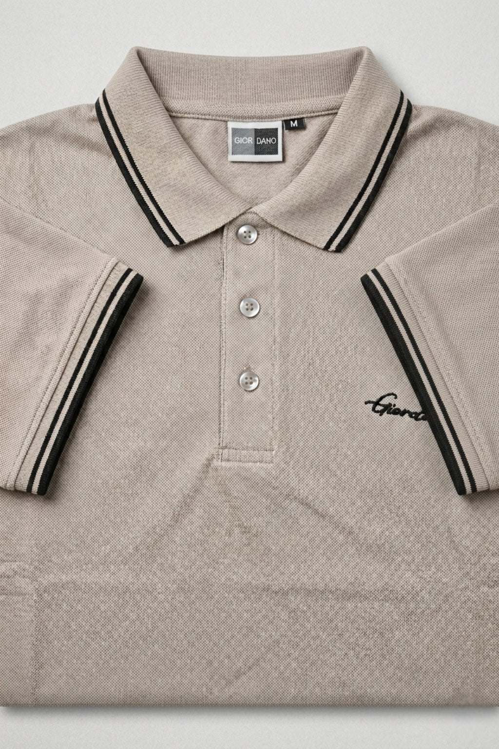 Close-up detail of Eliteez Signature Twin-Tip Polo - Taupe premium pique and embroidered logo.