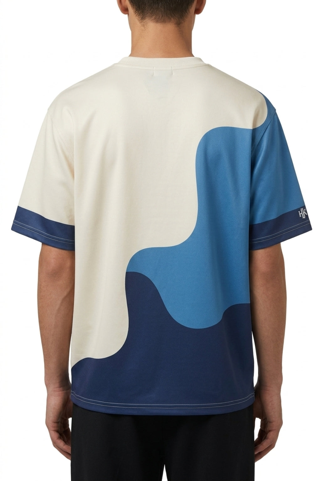 Cropped back view of model showing the oversized drape of the Strata Wave tee.