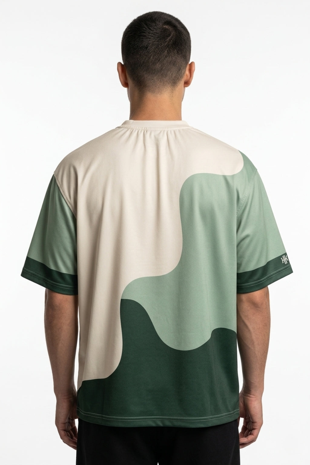 Cropped back view of model showing the oversized drape of the Strata Wave tee.