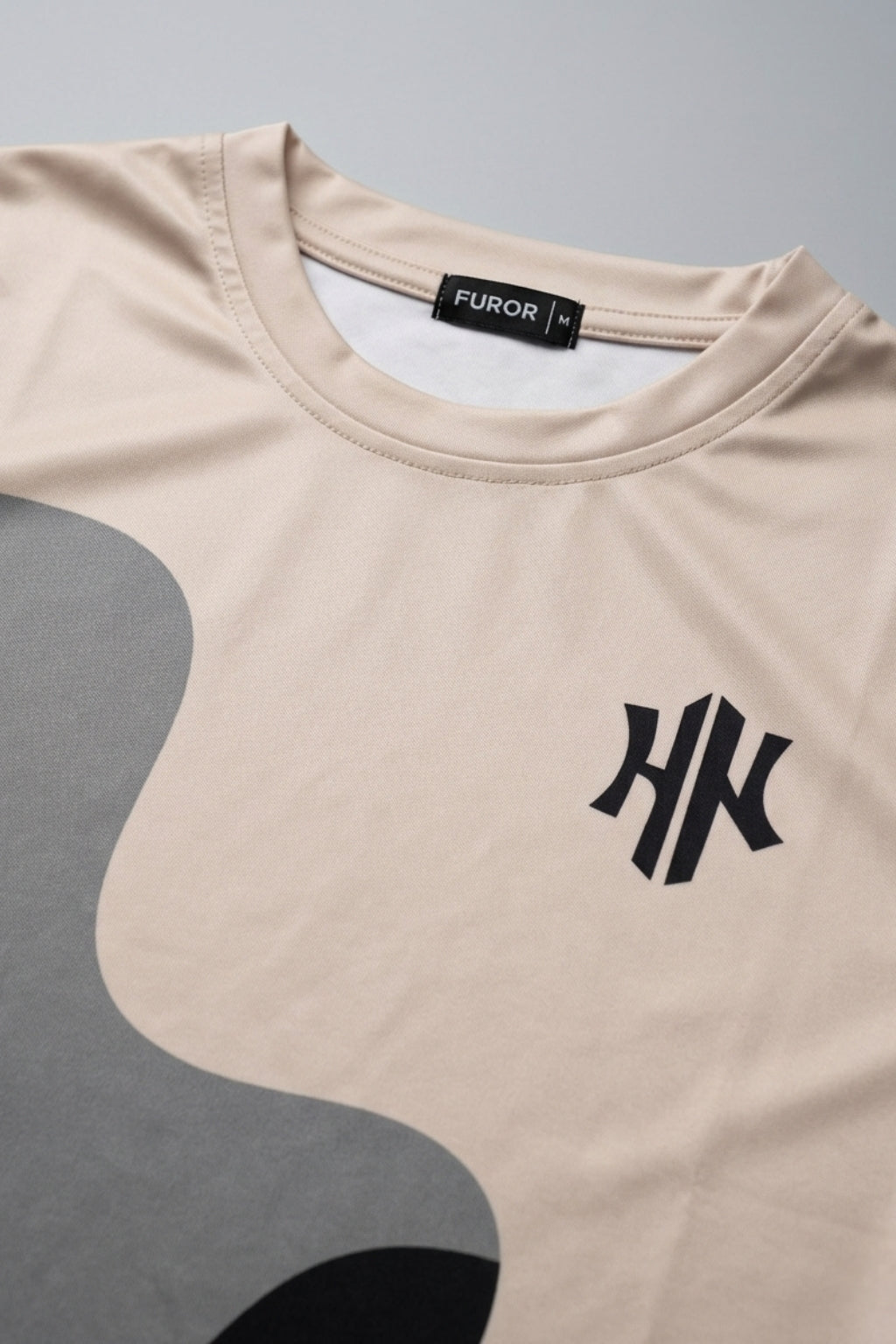 Close-up detail of the Strata Wave print and logo on Athletic Interlock fabric.