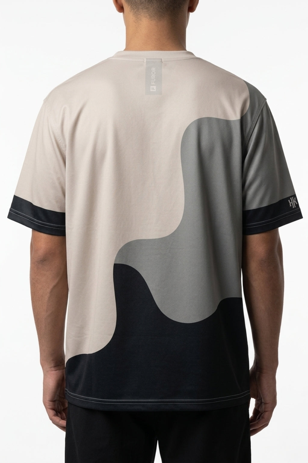 Cropped back view of model showing the oversized drape of the Strata Wave tee.