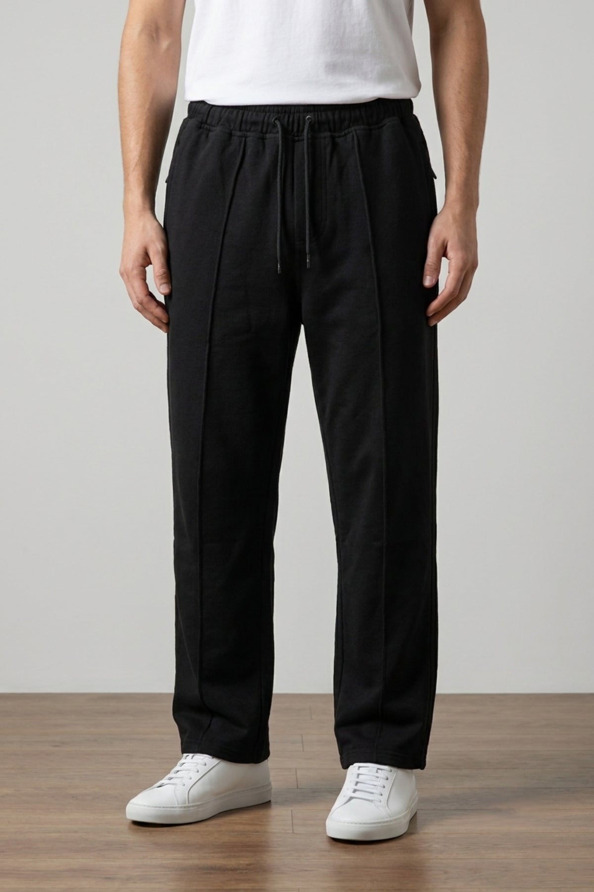 A male model wearing the Deep Black Classic Lounge Lightweight Terry Trousers with a tucked-in white t-shirt, viewed from the front.